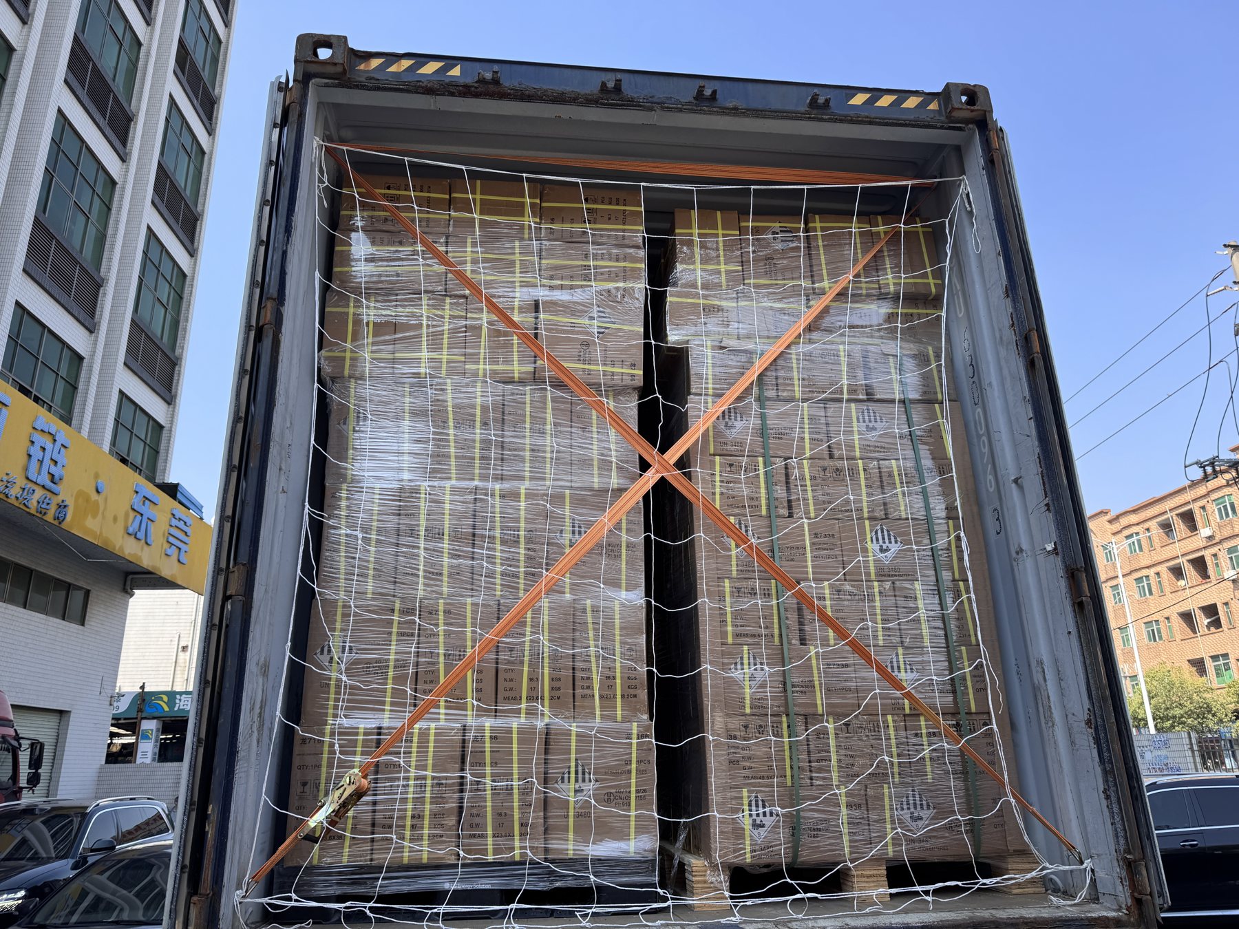 Palletized battery cartons being prepared for export loading